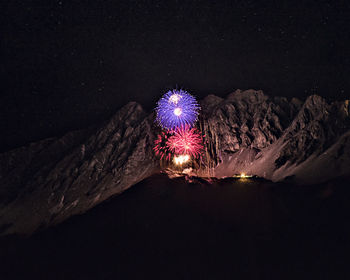 Illuminated light painting against sky at night