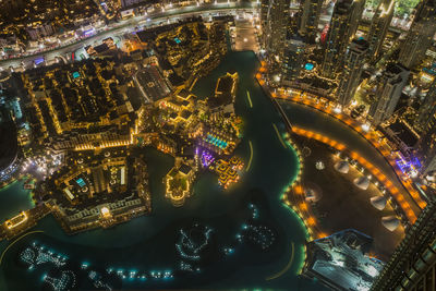 Aerial view of city lit up at night