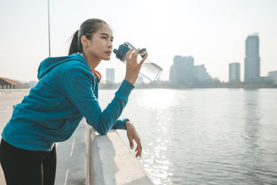 Side view of woman looking at city