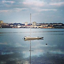 View of harbor against cloudy sky