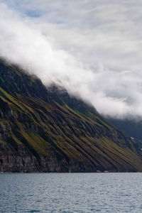 Scenic view of sea and mountains against sky