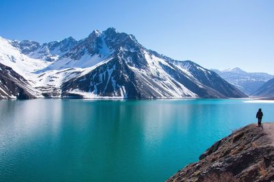 Scenic view of snowcapped mountains against clear blue sky