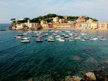 High angle view of townscape by sea against sky