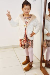 Portrait of a smiling young woman standing on floor