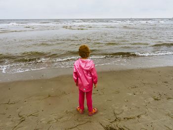 Rear view of a girl  standing on beach