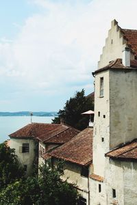 Houses in town against sky