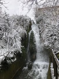 Scenic view of waterfall in forest during winter