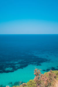 Scenic view of sea against clear blue sky