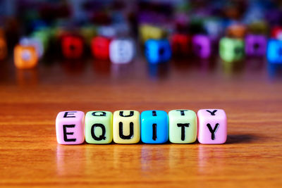 Close-up of text on multi colored toy blocks table