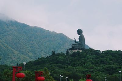 Low angle view of statue against cloudy sky