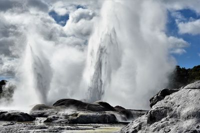 Panoramic view of waterfall against sky