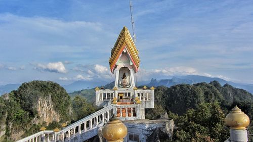 Temple by building against sky