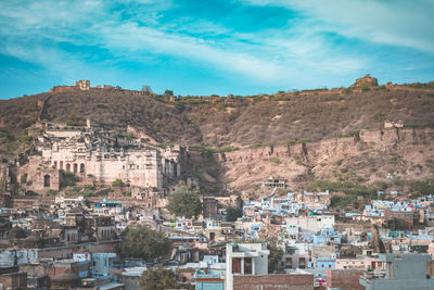 View of town against cloudy sky