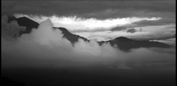 Scenic view of mountains against cloudy sky