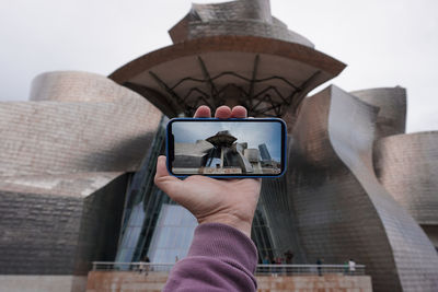 Low angle view of woman using mobile phone