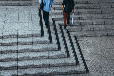 Low section of people walking on staircase