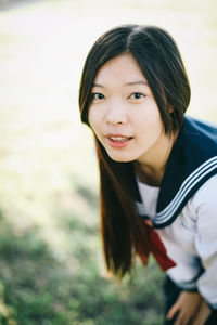 Portrait of beautiful woman standing against blurred background