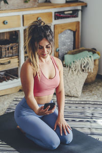 Beautiful young woman sitting at home