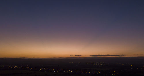 Scenic view of silhouette landscape against clear sky during sunset