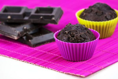 Close-up of cupcakes and chocolate bars on place mat