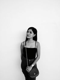 Portrait of woman standing against white background