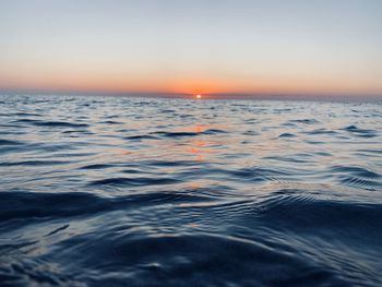 Scenic view of sea against clear sky during sunset