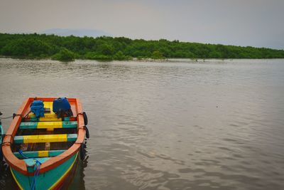 Boat floating on sea against sky