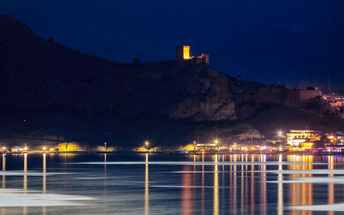 Night view of genoese fortress from water in crimea