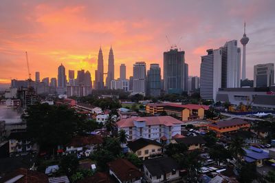 View of cityscape against cloudy sky