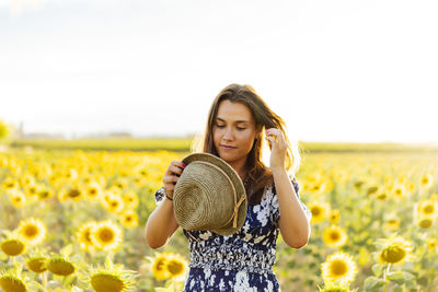 Beautiful young woman standing in field