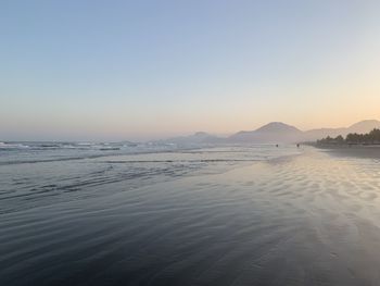 Scenic view of sea against clear sky during sunset