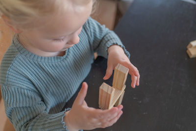 High angle view of boy playing with toy blocks