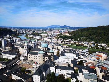 High angle view of buildings in town against sky