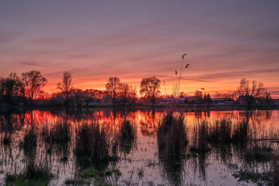 Scenic view of lake against romantic sky at sunset