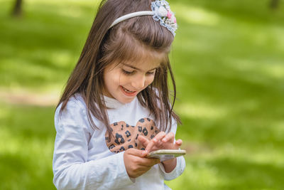 Cute girl holding baby playing