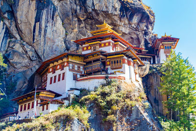 Buddhist temples on cliff against mountains