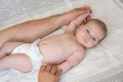 High angle view of cute baby on bed at home