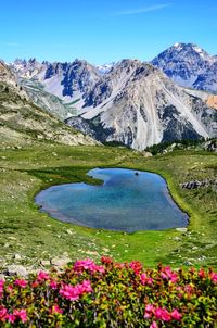 Scenic view of snowcapped mountains against blue sky