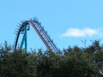 Low angle view of crane against blue sky