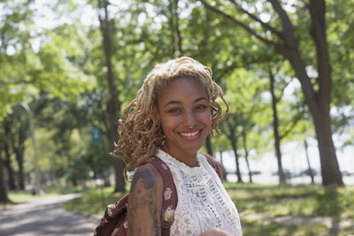 Portrait of a smiling young woman in park