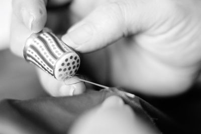 Close-up of hand holding cigarette