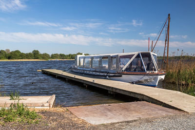 Pier over lake against sky