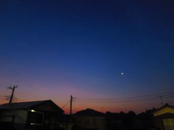 Low angle view of houses against sky at night