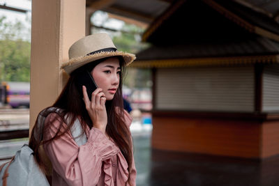 Portrait of young woman wearing hat