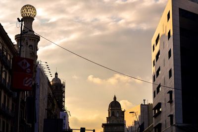 Low angle view of building against cloudy sky