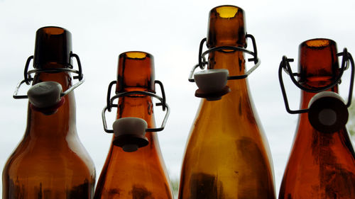 Close-up of wine bottles against white background