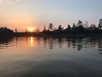 Scenic view of lake against sky during sunset