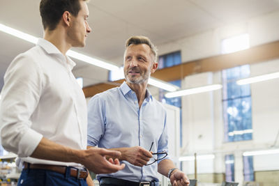 Two businessmen discussing in factory