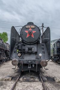 Abandoned train on railroad track against sky