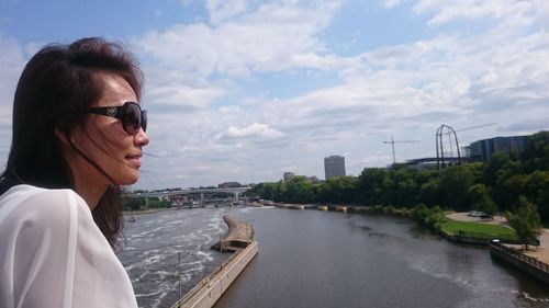 Woman in sunglasses against sea